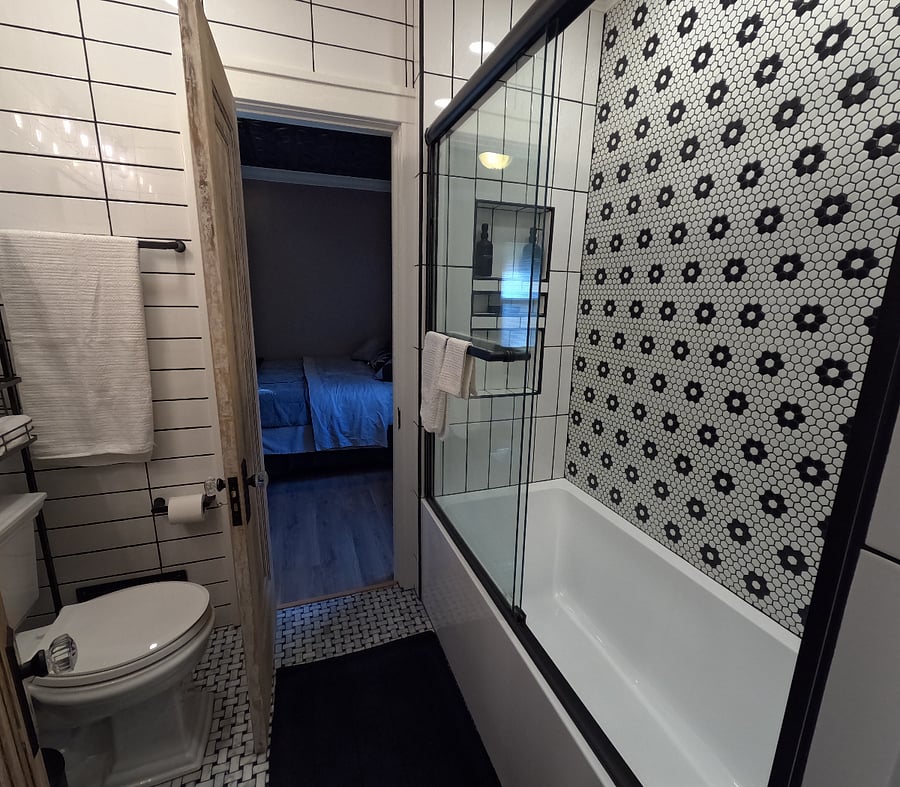 Beautifully remodeled Jack & Jill style bathroom with a fresh classic look & soft water shower.