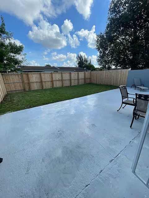 Private fenced in backyard with grill