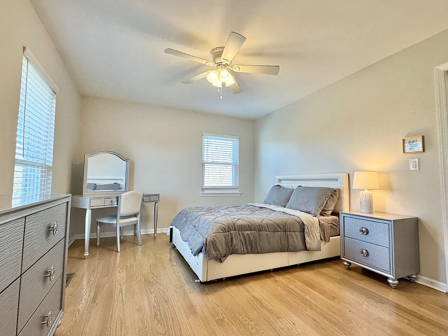 Bedroom 2 with full sized bed, double closet, dresser, and work desk.