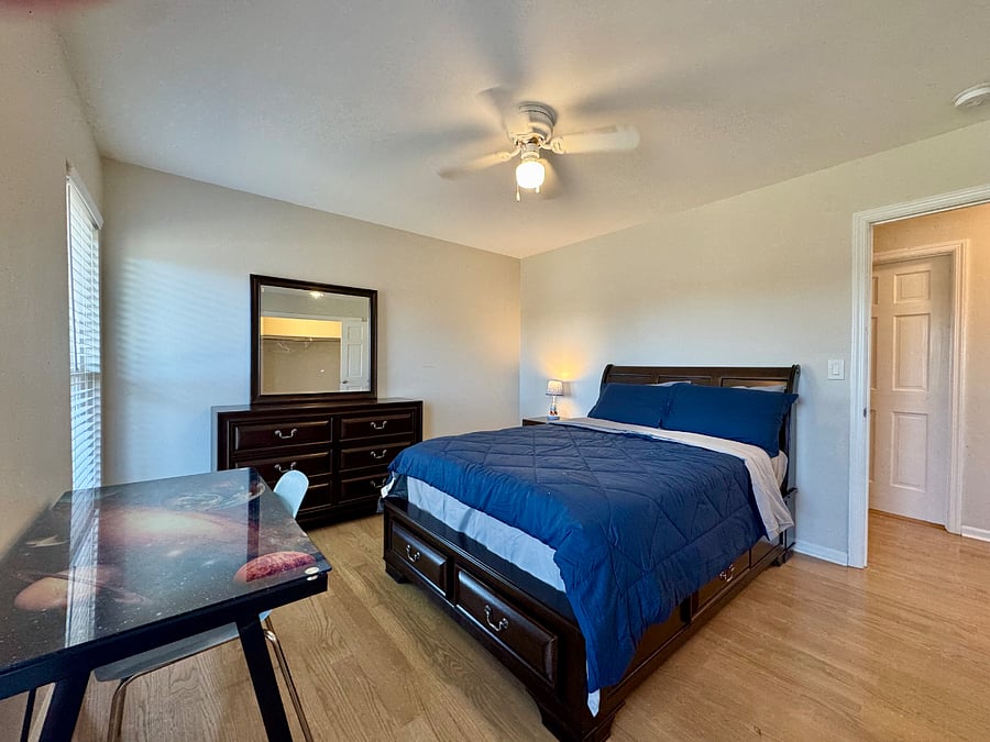 Bedroom 3 with full sized bed, large closet, work desk, and some lake views.