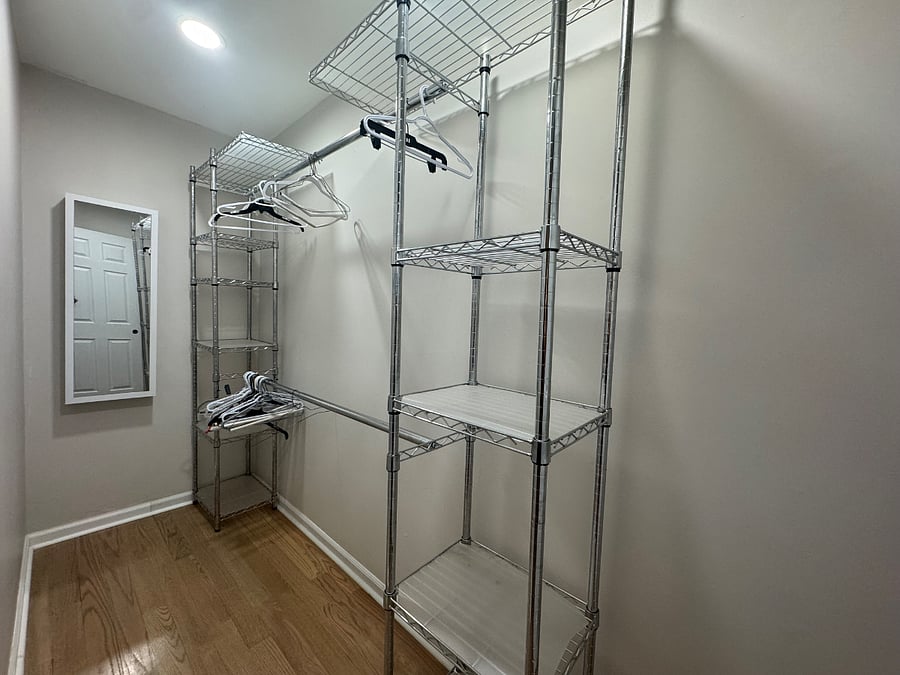 Primary bedroom walk in closet