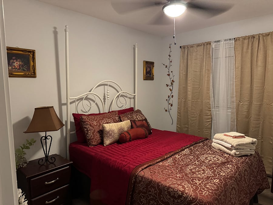 Bedroom #3 feature full sized bed, black out curtains, ceiling fan, night stand, walk-in closet, extra towels, hangers, sheet and a laundry basket.
