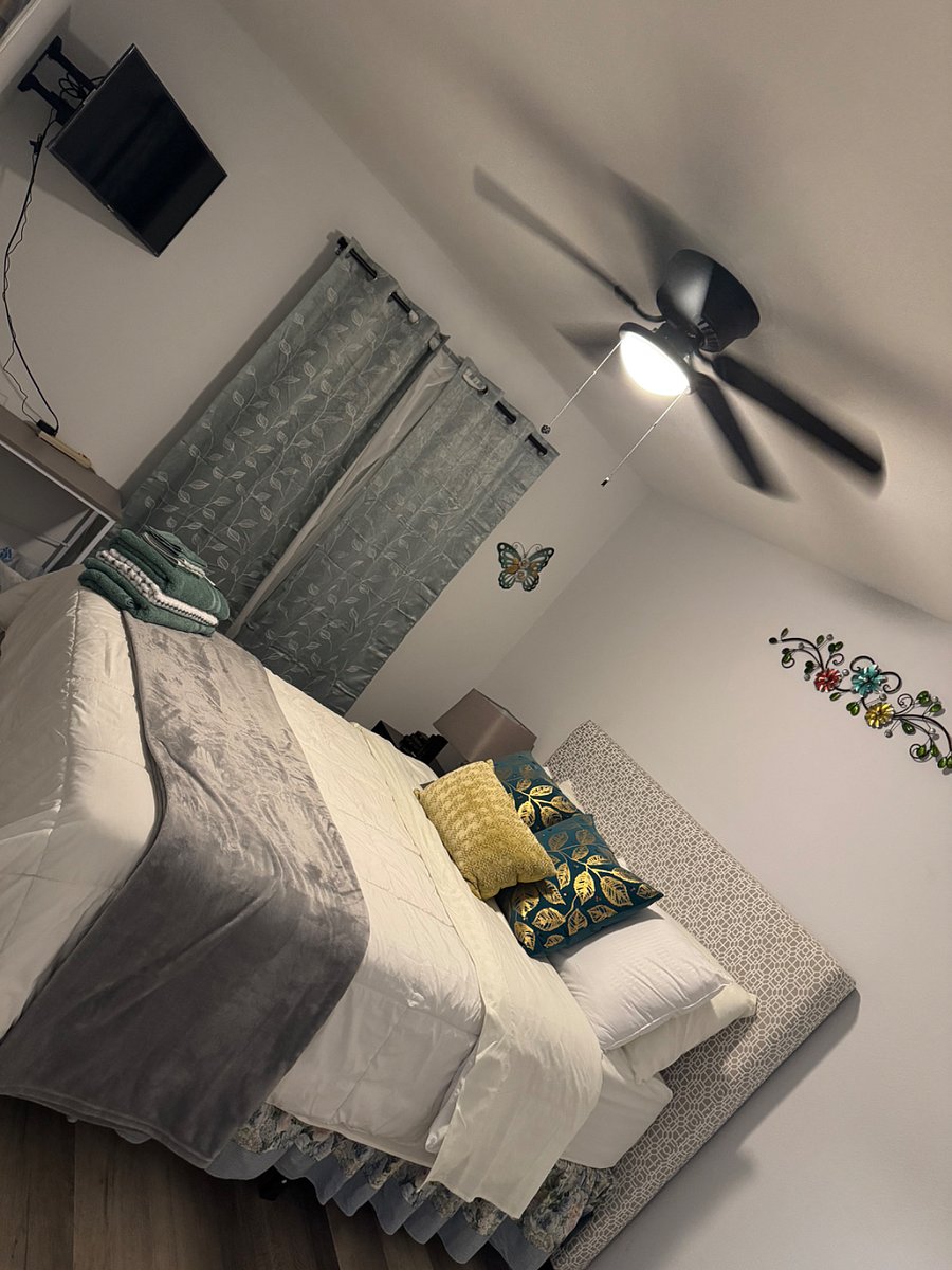 Bedroom#2 features a T.v, fan , computer desk, bed side lamp.