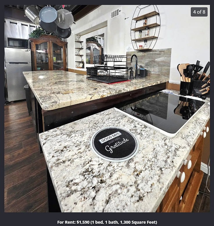 The kitchenette has granite countertop, sink, two burner induction stove, pots and utensils.