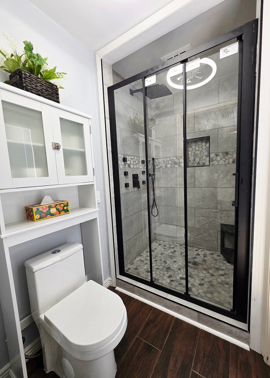 The bathroom has a step in shower