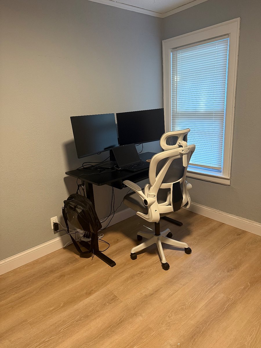 Second bedroom used as home office. Adjustable height desk with ergonomic chair and dual monitors