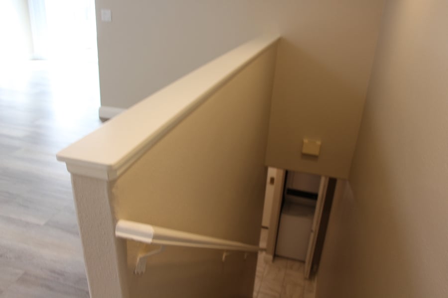 Stairs down to lower level of unit, built in washer/dryer