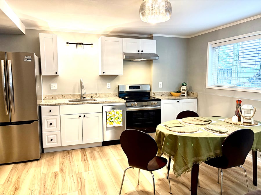 Kitchen with electric stove , dishwasher, hood fan, refrigerator with ice