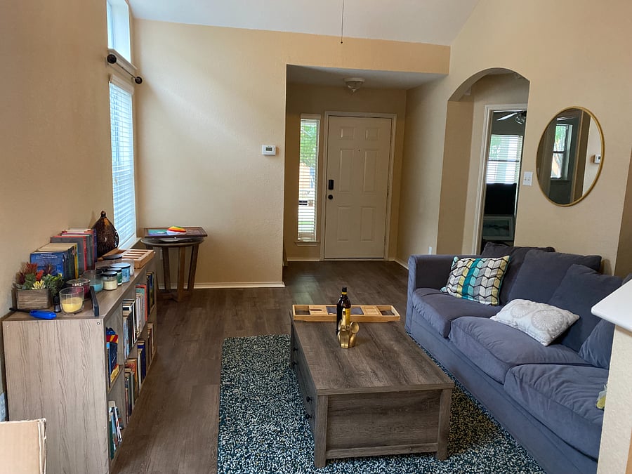 Living room and the front door, your room is the room to the right.
