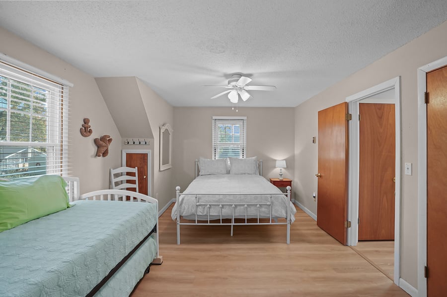 Upstairs bedroom with queen bed and a trundle bed with 2 twin beds
