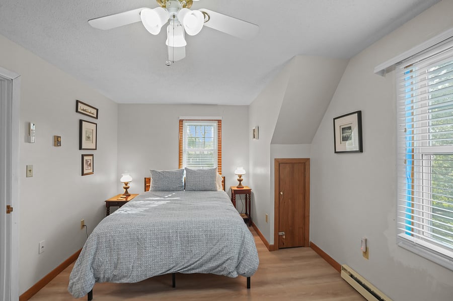 Upstairs bedroom with queen bed and work space
