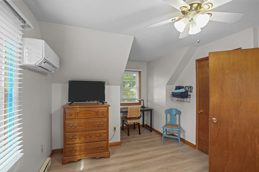 Upstairs bedroom with queen bed and work space