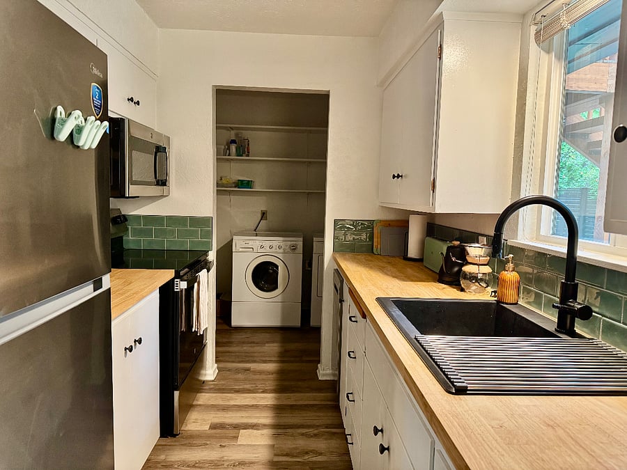 The kitchen exits to the laundry room, which has a door to the garage and a door to the backyard.