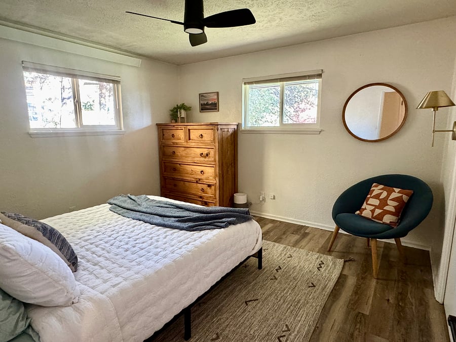 Front bedroom with new bedframe, mattress, and luxury bedding. Cozy reading nook.