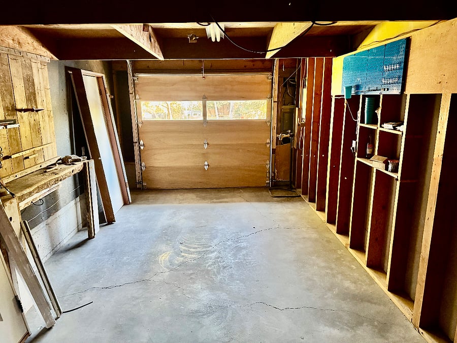 Garage with room for your gear, pegboard, and workbench.