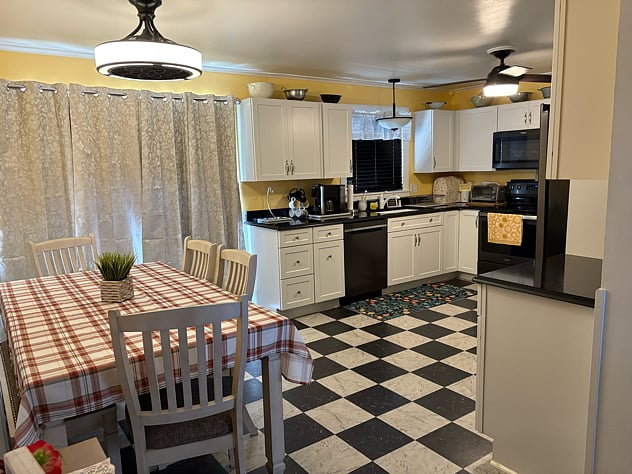 Kitchen with dishwasher, microwave, smooth-top stove, refrigerator with ice maker in freezer
