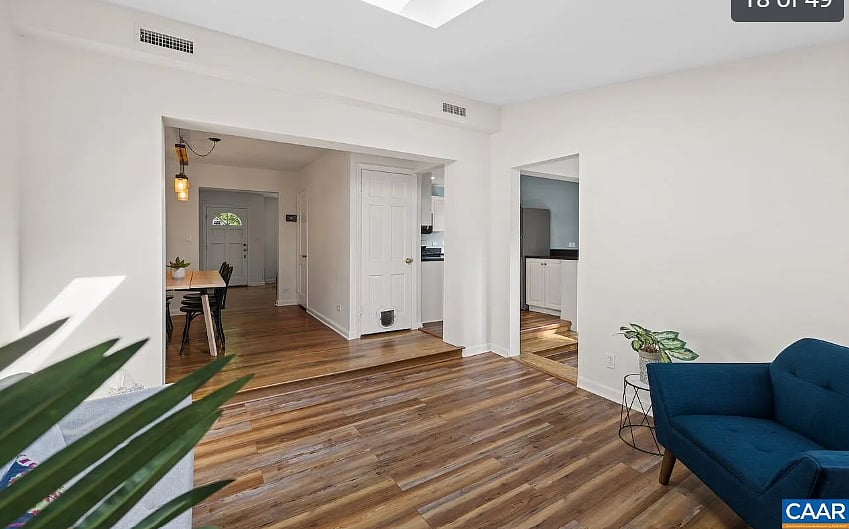 view of kitchen and front door from living room
