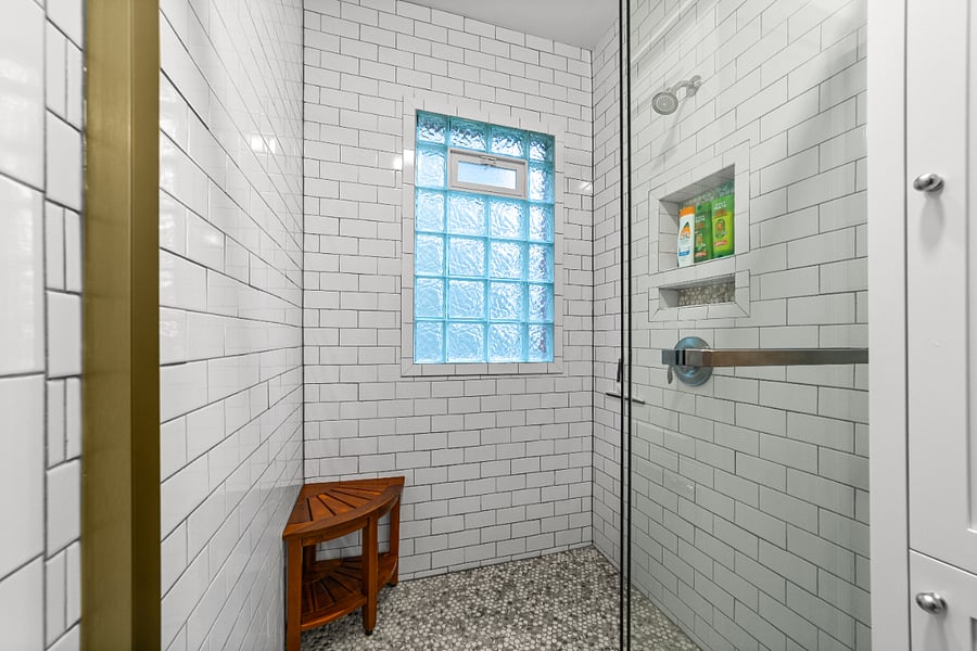 Subway tile shower with cubby and bench