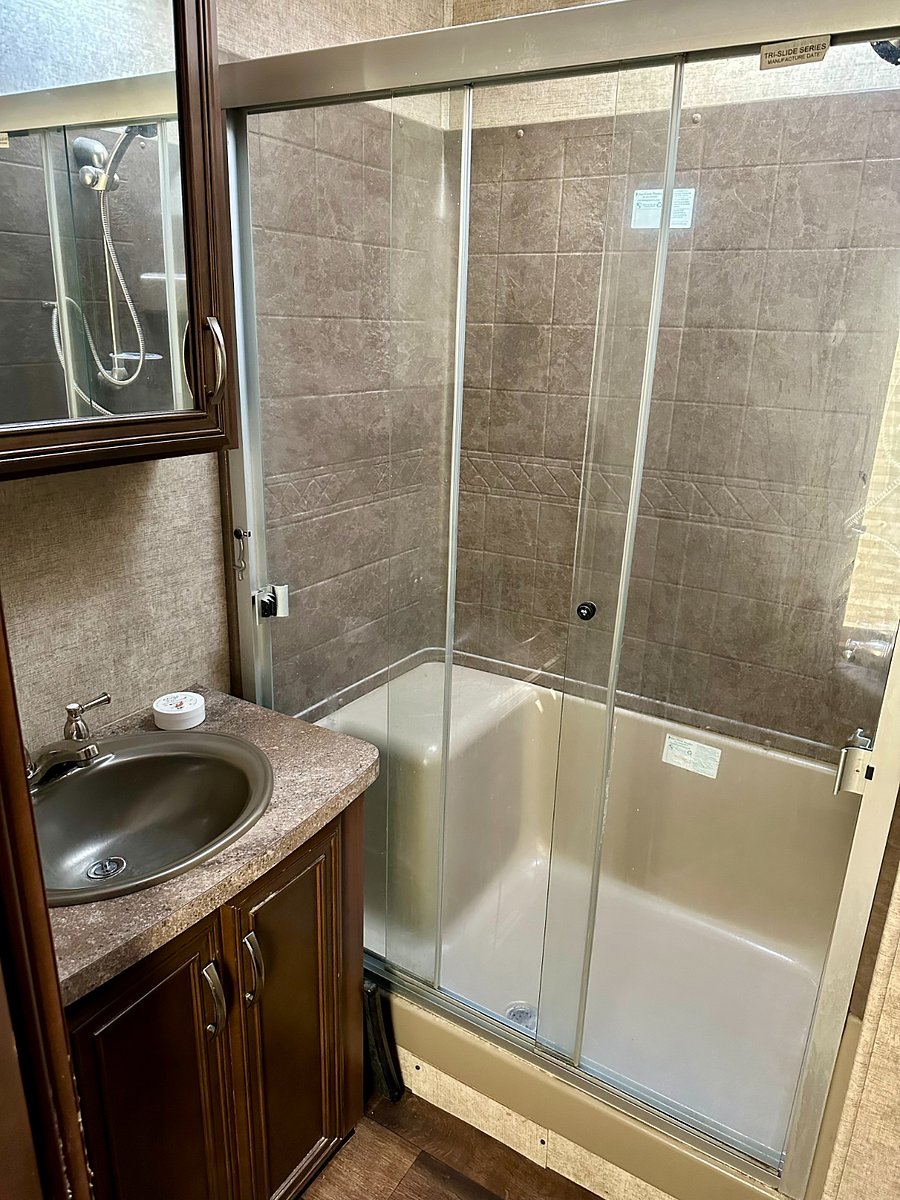 Standard bathroom, sink, toilet, and shower.