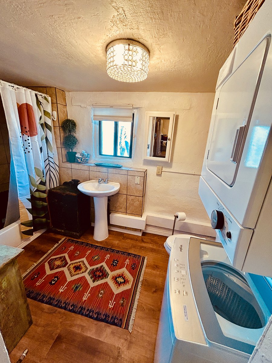 Spacious Boho themed bathroom with brand new washer & dryer. New wood floors and two garden windows that opens up to the backyard.