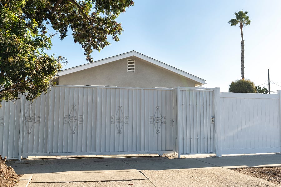 Secured driveway gate with locked pedestrian gate