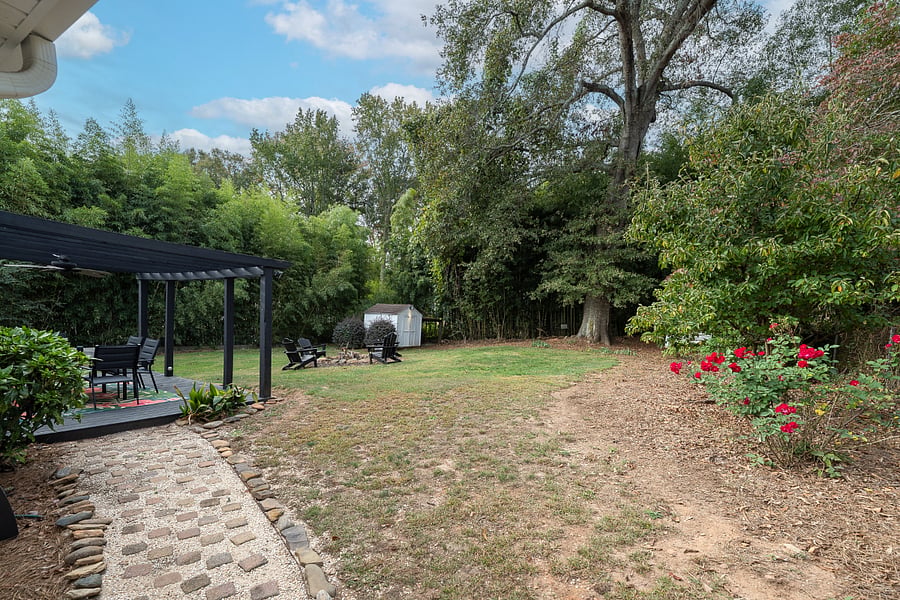 Large fenced backyard with deck and firepit