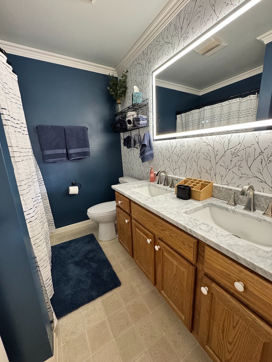 Bathroom w/ double vanity and LED mirror