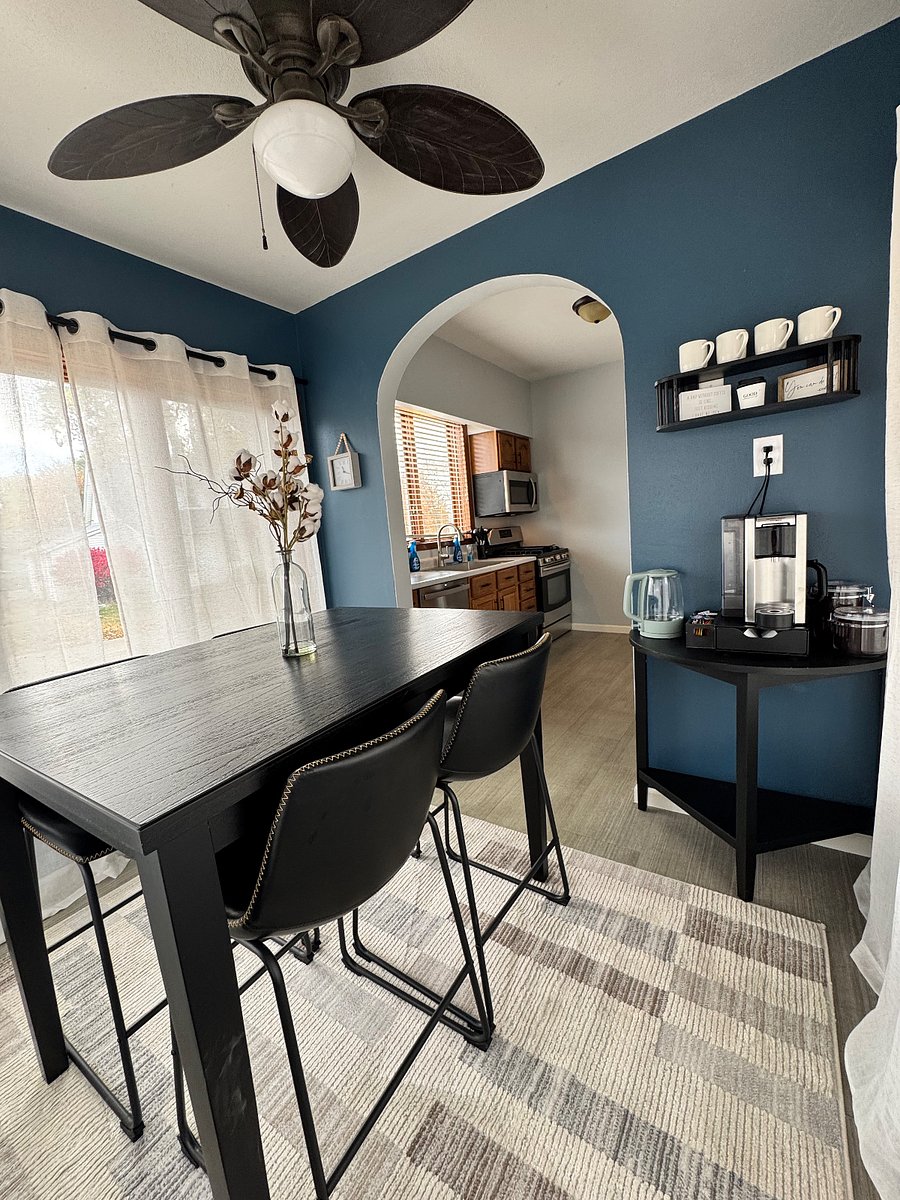 Table off the kitchen with natural light from windows and coffee bar