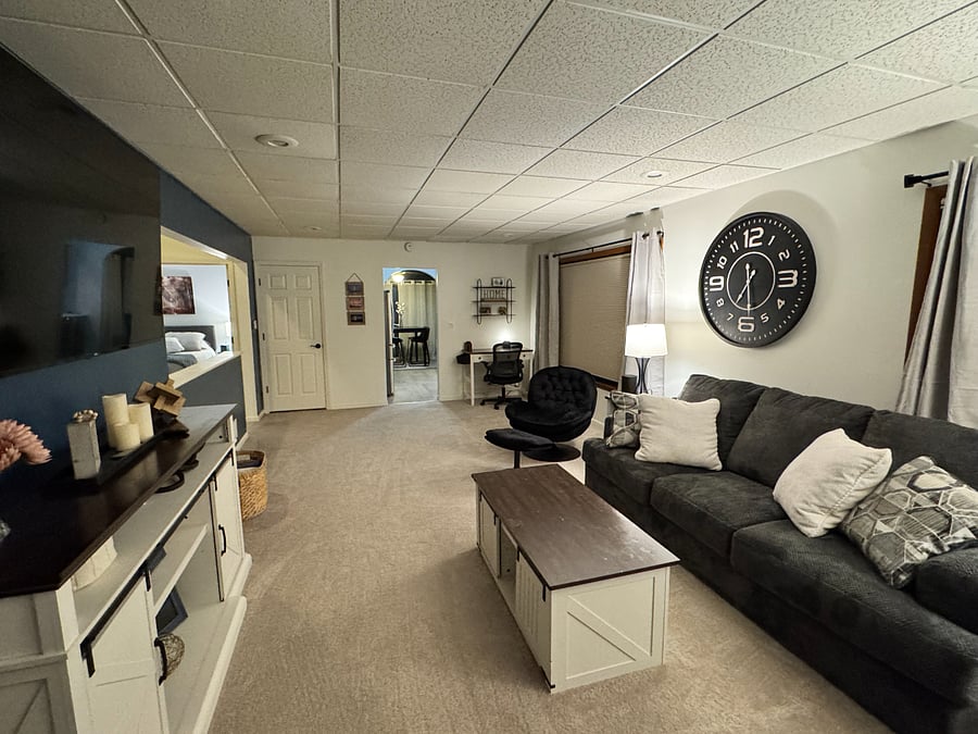 Living Room with Couch, Love Seat, Chair, two end tables, coffee table and 65 inch smart TV
