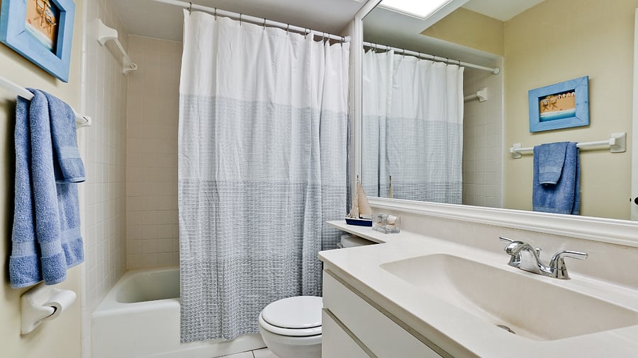 Guest bedroom bath has tub/shower combo.