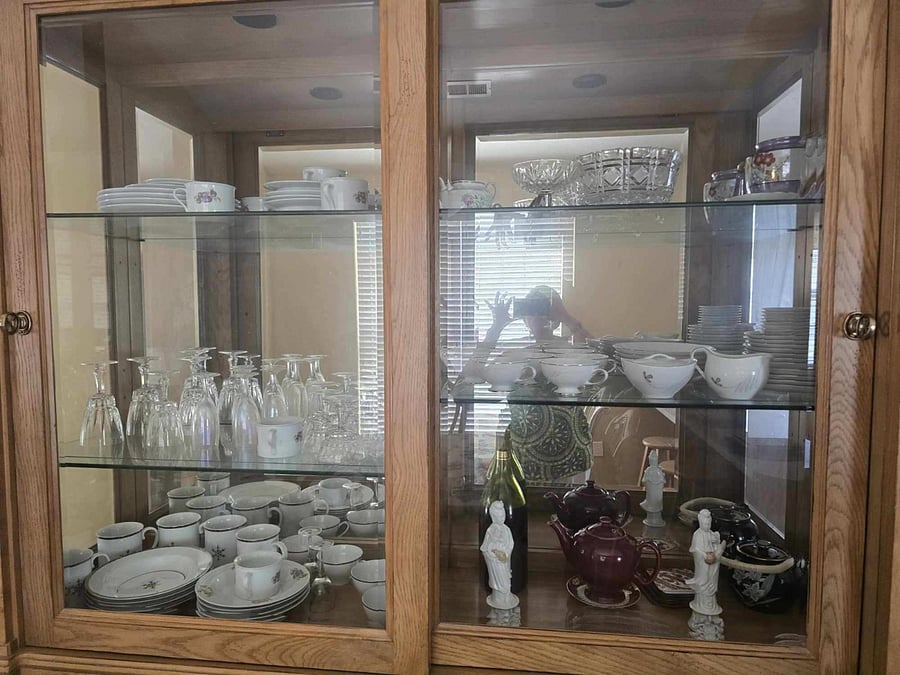A stylish china cabinet displays dishware, glassware, and elegant serving pieces  ready for hosting dinners or enjoying quiet meals at home.