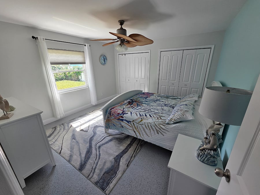 master bedroom with king size bed, an oversized closet, and large dresser. 
