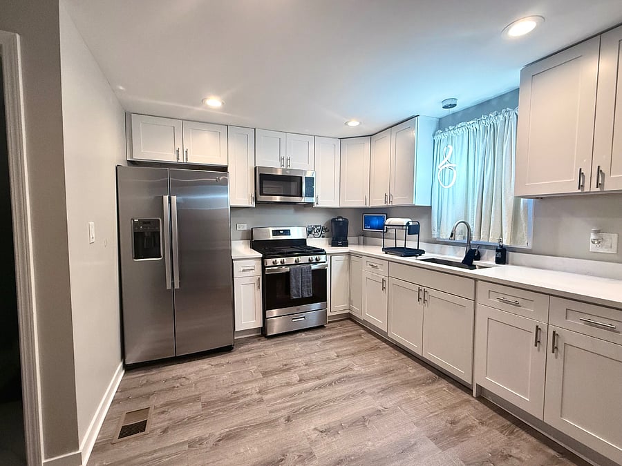 Fully equipped kitchen with stainless steel appliances, gas stove, Keurig coffee maker, and complete dish-ware for guest use. An Alexa Smart screen is available for music or streaming while you cook. Bright modern space designed for convenience. 