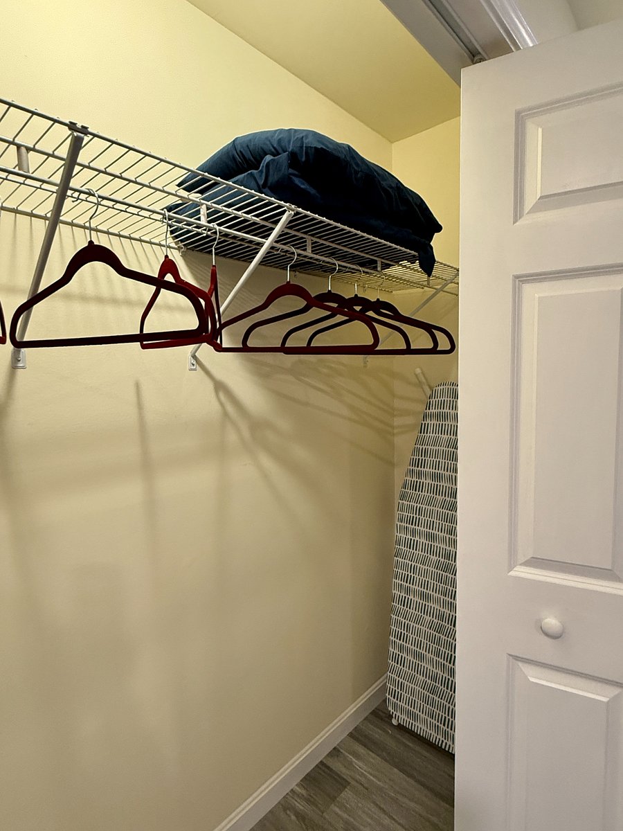 Closet with plenty of storage, ironing board