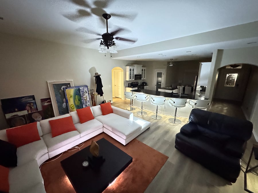 Spacious living room with smart TV, and comfortable seating for movie nights.