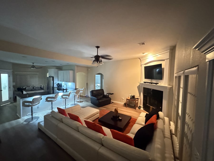 Spacious living room with smart TV, and comfortable seating for movie nights.