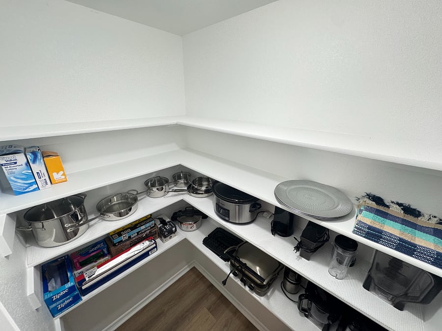 Fully stocked pantry with cookware, utensils, blender, slow cooker, and all the essentials for easy home cooking.