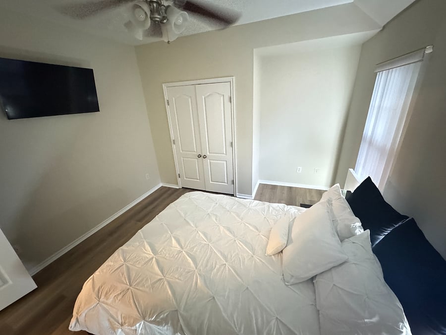 Private 3rd bedroom with smart TV, workspace, and comfortable queen bed.