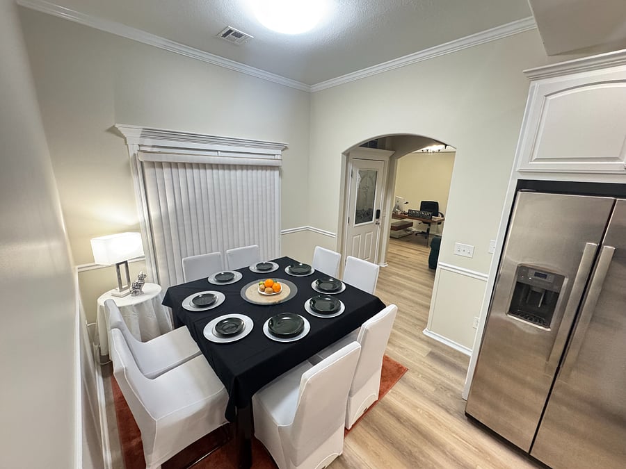 Bright dining space with table and chairs for eight perfect for family meals or meetings.