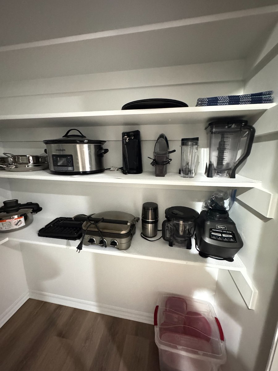 Fully stocked pantry with cookware, utensils, blender, slow cooker, and all the essentials for easy home cooking.
