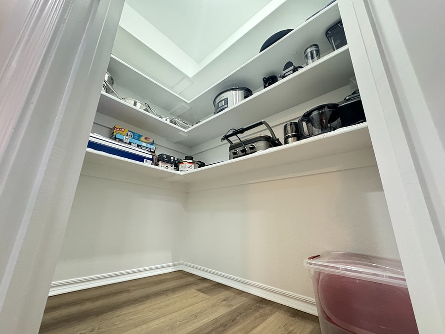 Fully stocked pantry with cookware, utensils, blender, slow cooker, and all the essentials for easy home cooking.