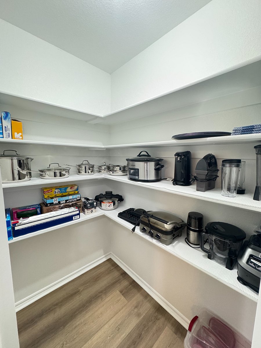 Fully stocked pantry with cookware, utensils, blender, slow cooker, and all the essentials for easy home cooking.