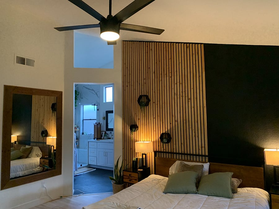 bedroom leading to private master bathroom with walk in closet, shower, toilet