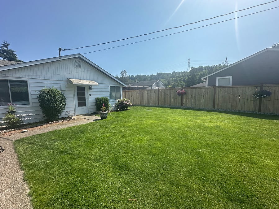 Front yard, fully fenced. Landscaping crew takes care of yard year-round.