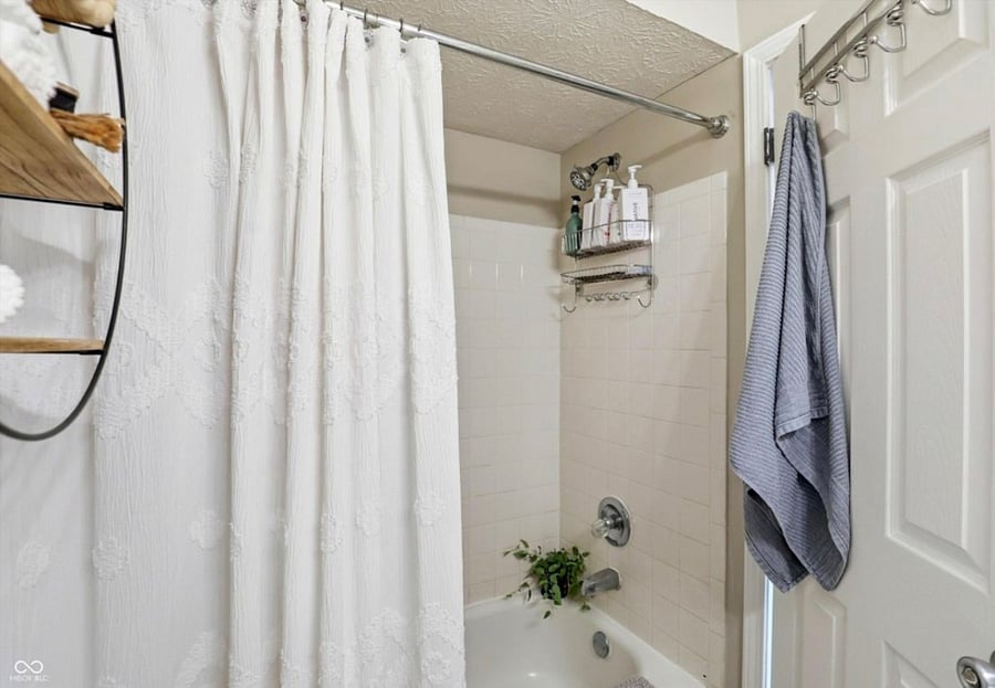 All white tub and shower combo. 