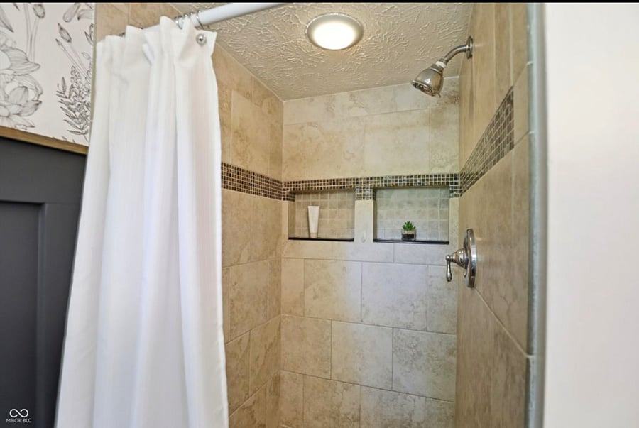 Tiled walk in shower with light