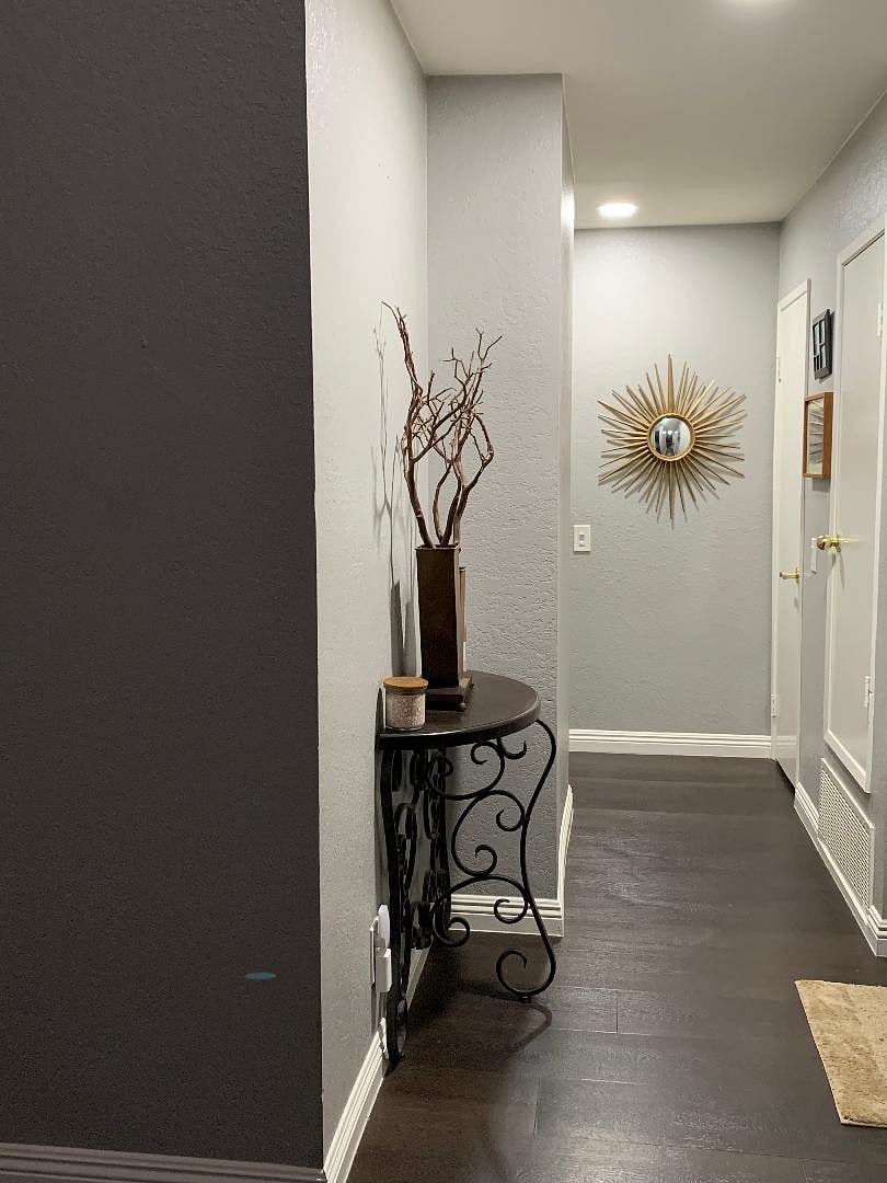 Front door entry way/hallway leading to primary and secondary bedrooms.