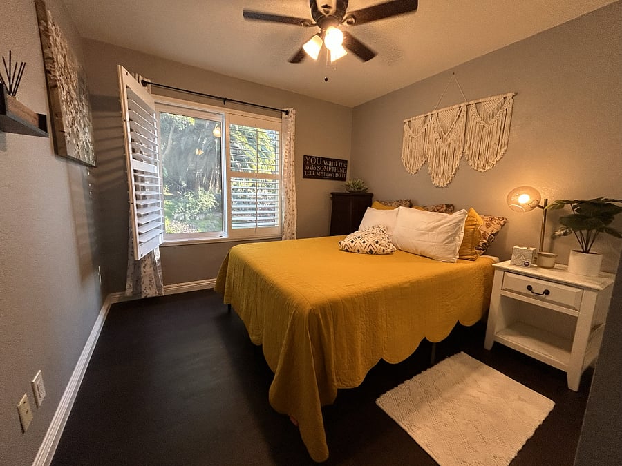 Secondary Bedroom. Comes with a separate bathroom, a large closet, two dressers, a bedside table, and a view of the outdoor pool.