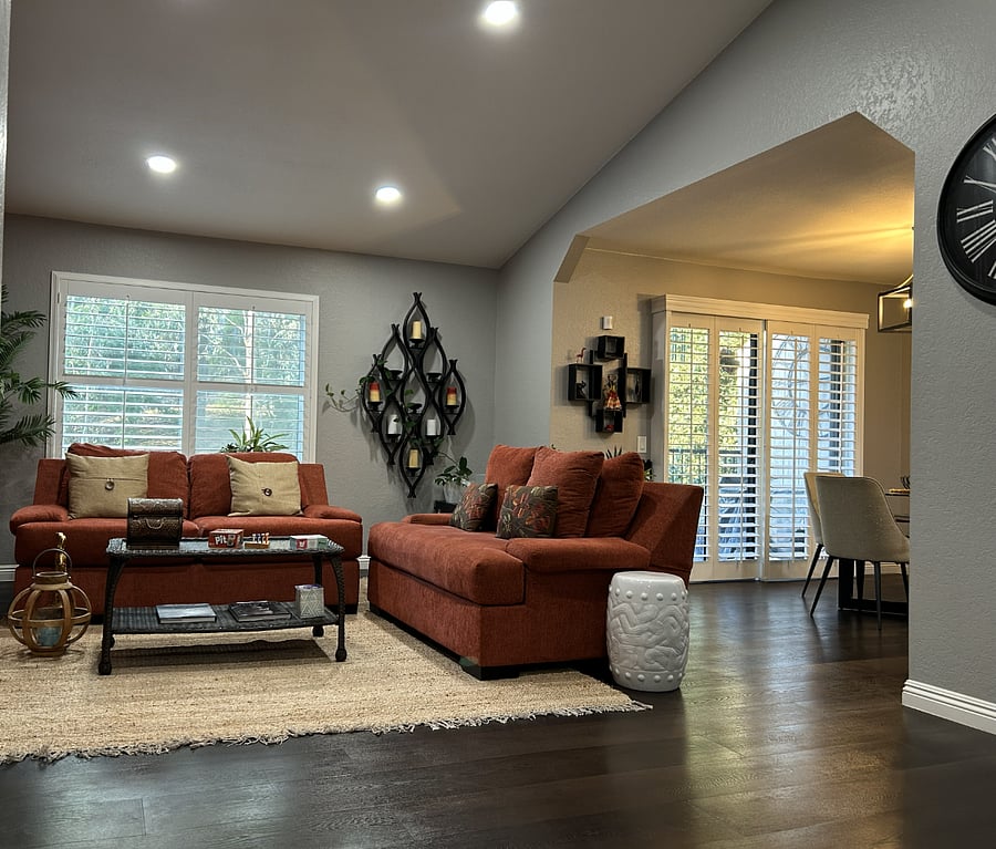 Living Room. Features a built-in fireplace (electric and safe for kids), flat screen TV with streaming access, brand new thermostat, and window shutters.