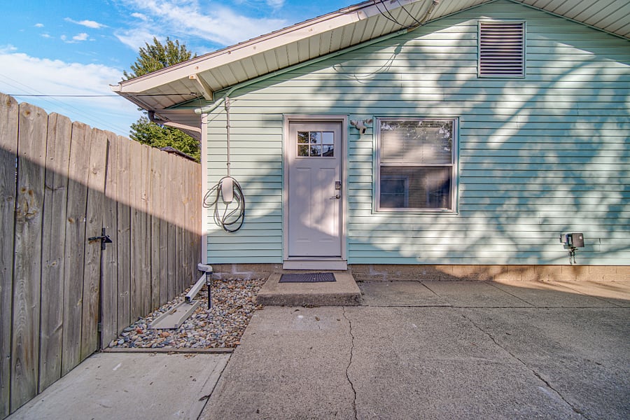 Side entrance to the house and into the spacious fenced in back yard. Plus, a convenient EV charger for electric vehicles.